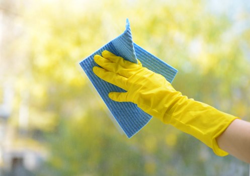 Technician wearing PPE while cleaning a carpet